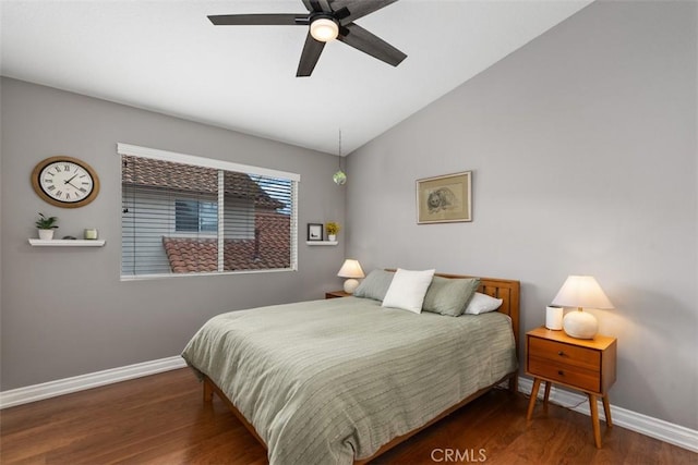 bedroom with baseboards, lofted ceiling, and wood finished floors