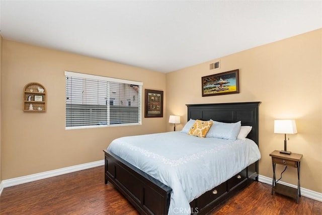 bedroom featuring visible vents, dark wood-type flooring, and baseboards