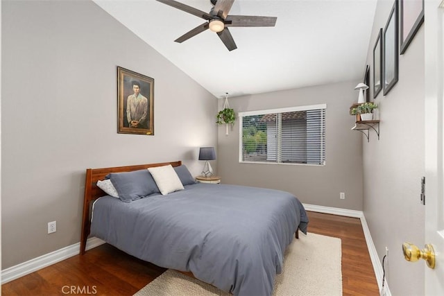 bedroom with a ceiling fan, lofted ceiling, wood finished floors, and baseboards