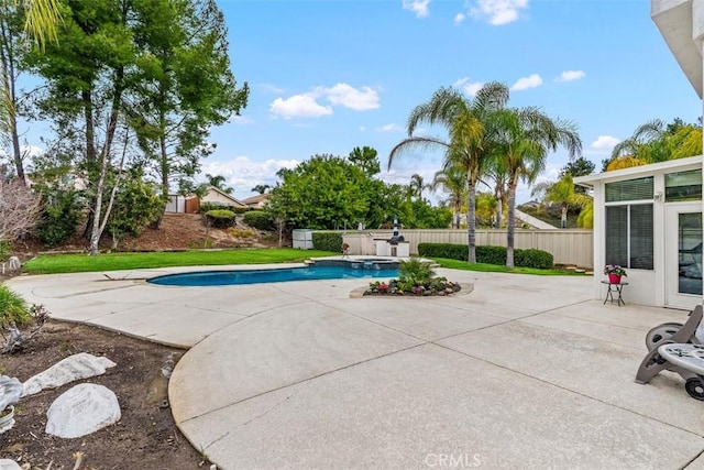 view of pool with fence, a pool with connected hot tub, and a patio area