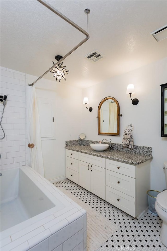 full bathroom featuring tile patterned floors, visible vents, toilet, and vanity