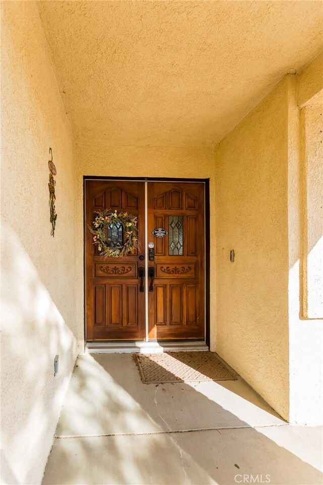 doorway to property with stucco siding