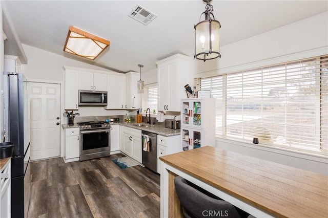 kitchen with white cabinets, visible vents, appliances with stainless steel finishes, and a sink