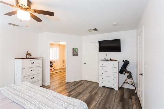 bedroom featuring visible vents, baseboards, wood finished floors, and a ceiling fan