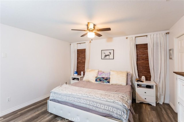 bedroom with a ceiling fan, wood finished floors, and baseboards