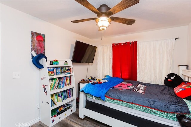 bedroom featuring a ceiling fan and wood finished floors