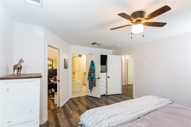 bedroom with ceiling fan, visible vents, ensuite bath, and dark wood-style floors