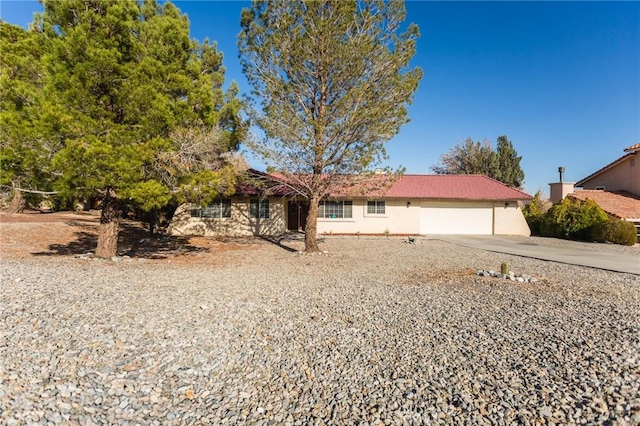 view of front of house with an attached garage, driveway, and stucco siding