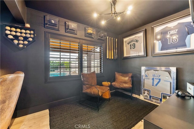 living area with baseboards and wood finished floors