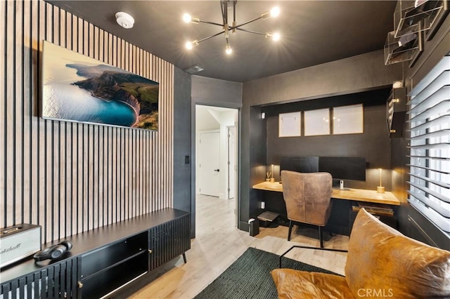 office featuring wood finished floors, visible vents, and a chandelier