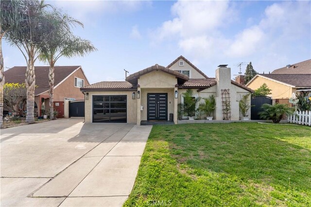 view of front of home with stucco siding, driveway, an attached garage, and fence