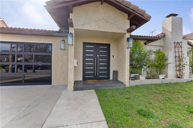 doorway to property with stucco siding and a lawn