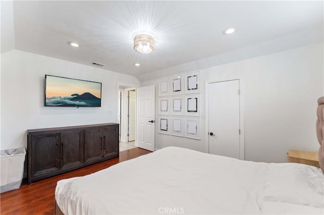 bedroom featuring dark wood finished floors, recessed lighting, and visible vents