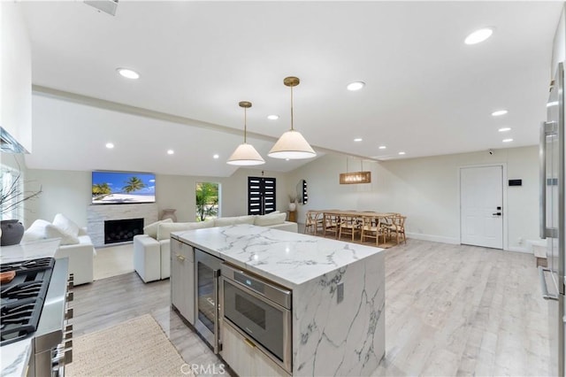 kitchen featuring decorative light fixtures, appliances with stainless steel finishes, recessed lighting, and light wood finished floors