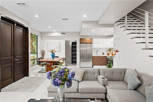 living room featuring visible vents, recessed lighting, and stairway