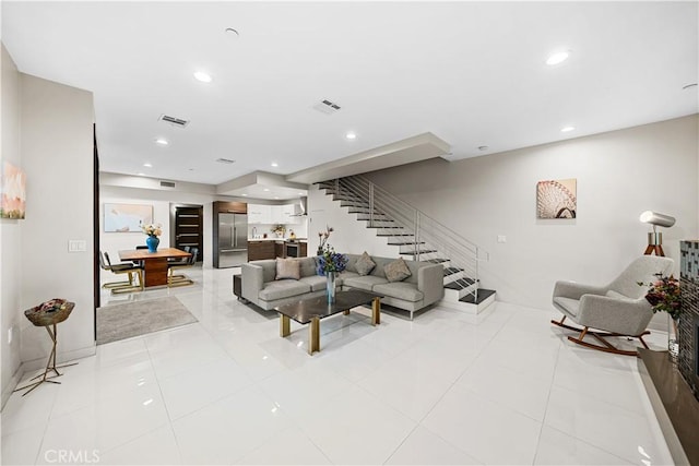 living area with recessed lighting, stairway, visible vents, and light tile patterned floors