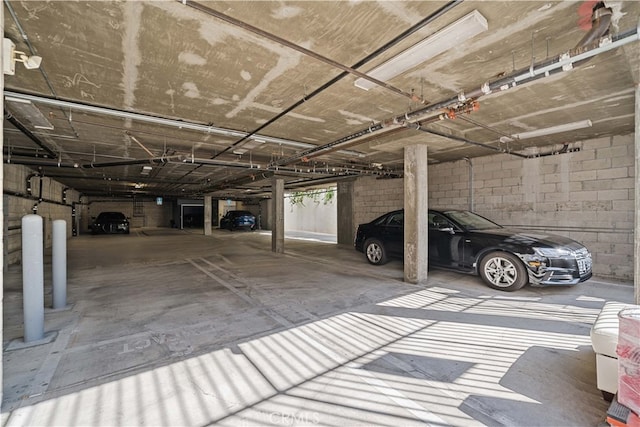 parking deck featuring concrete block wall