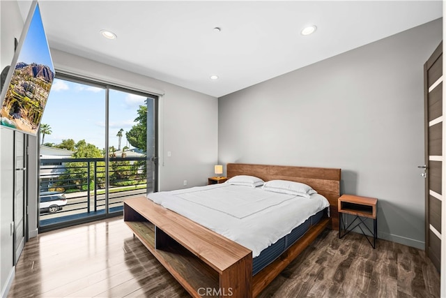 bedroom featuring access to exterior, recessed lighting, wood finished floors, and baseboards