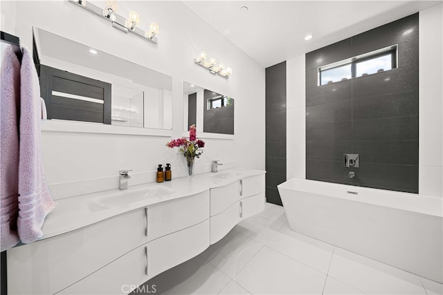 full bath with double vanity, a soaking tub, tile patterned floors, and a sink