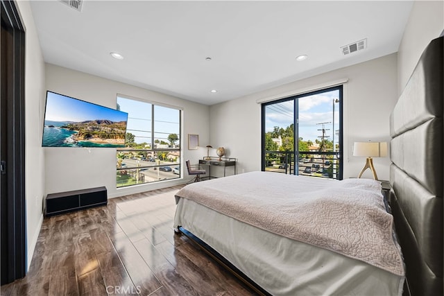 bedroom with recessed lighting, visible vents, multiple windows, and wood finished floors