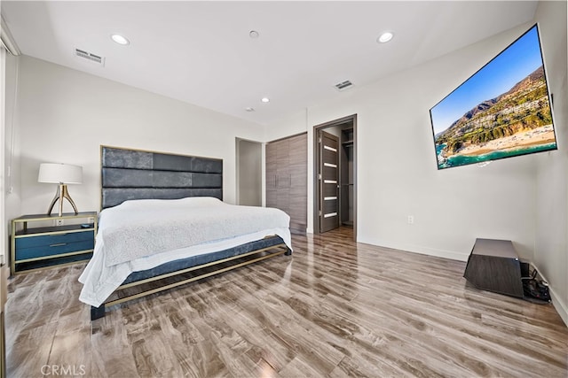 bedroom with recessed lighting, visible vents, and wood finished floors