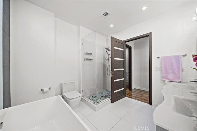 bathroom featuring visible vents, recessed lighting, a sink, tile patterned flooring, and a shower stall