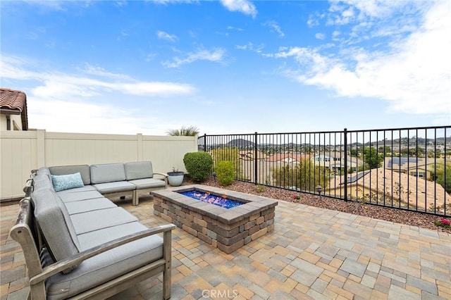 view of patio / terrace featuring an outdoor living space with a fire pit and a fenced backyard