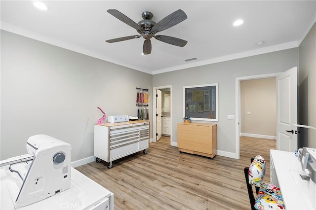 interior space featuring baseboards, crown molding, and light wood finished floors