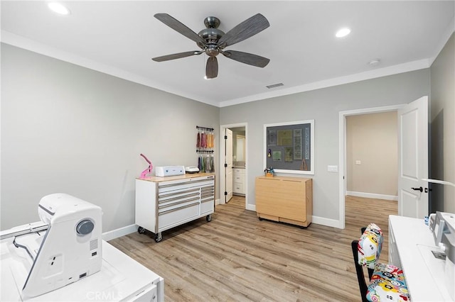 interior space featuring light wood finished floors, crown molding, and ceiling fan