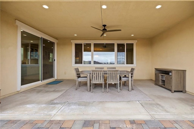 view of patio with outdoor dining area and a ceiling fan