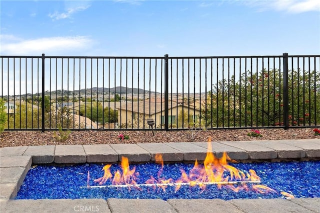 view of pool featuring an outdoor fire pit and fence