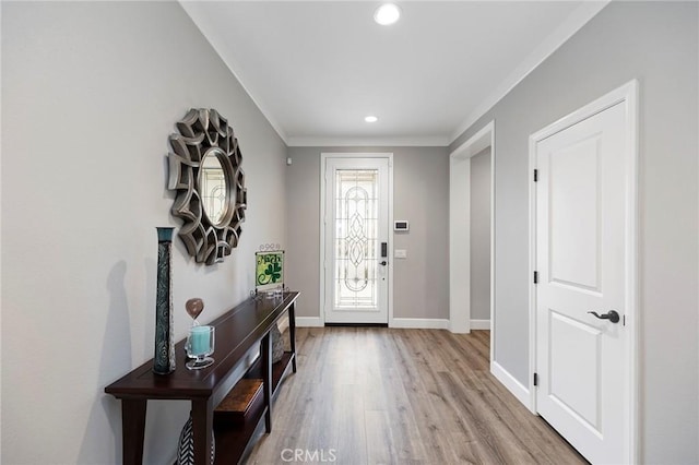 foyer with recessed lighting, crown molding, light wood-type flooring, and baseboards