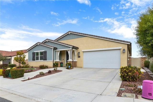 ranch-style house with stucco siding, an attached garage, driveway, and fence