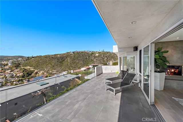 view of patio with a mountain view and a balcony