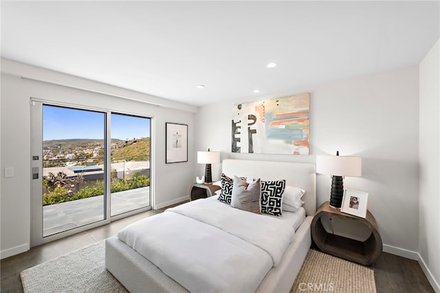 bedroom with access to exterior, recessed lighting, and baseboards