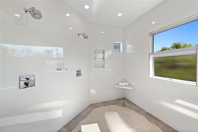 full bath featuring tile patterned flooring and tiled shower