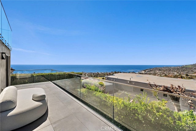 balcony featuring a water view