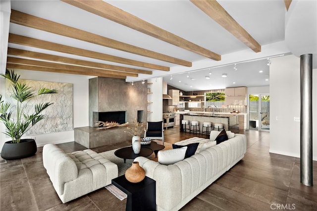 living area with beamed ceiling and a premium fireplace