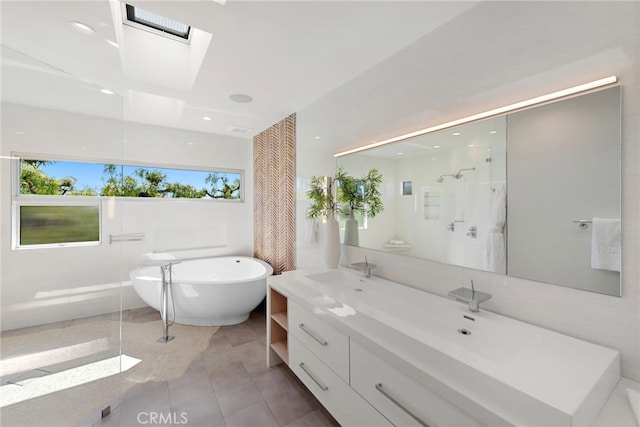 full bath featuring a walk in shower, a sink, a skylight, double vanity, and a freestanding bath