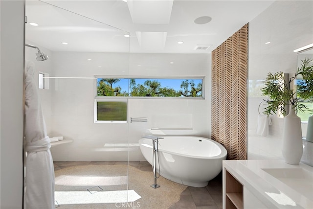 full bath featuring tile patterned floors, visible vents, a freestanding bath, walk in shower, and vanity