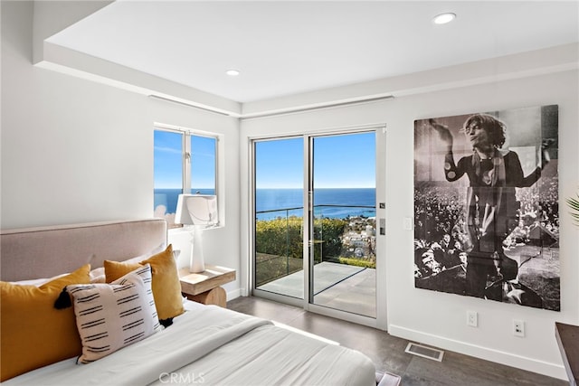 bedroom with visible vents, baseboards, wood finished floors, and access to outside