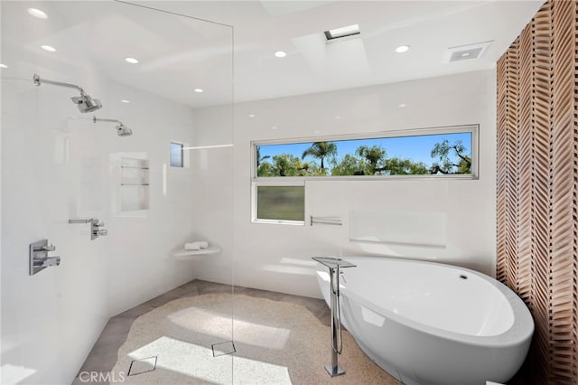 full bath featuring recessed lighting, a walk in shower, and a freestanding bath