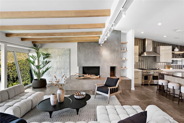 living room featuring beamed ceiling, recessed lighting, and a lit fireplace