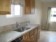 kitchen with a sink, brown cabinets, and light countertops