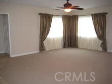 spare room with plenty of natural light and a ceiling fan