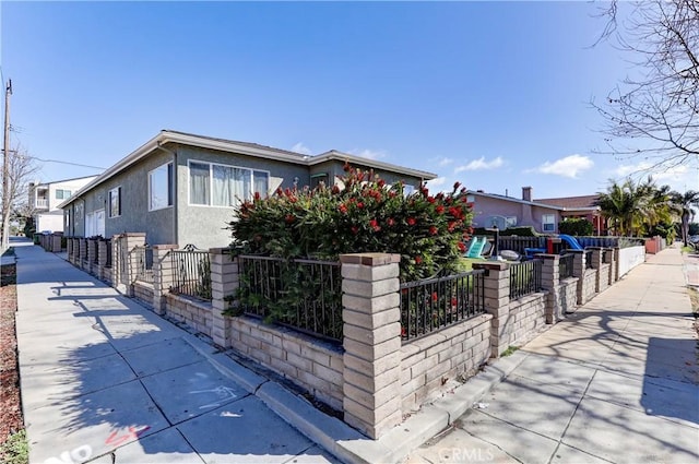 view of front facade with a fenced front yard and stucco siding