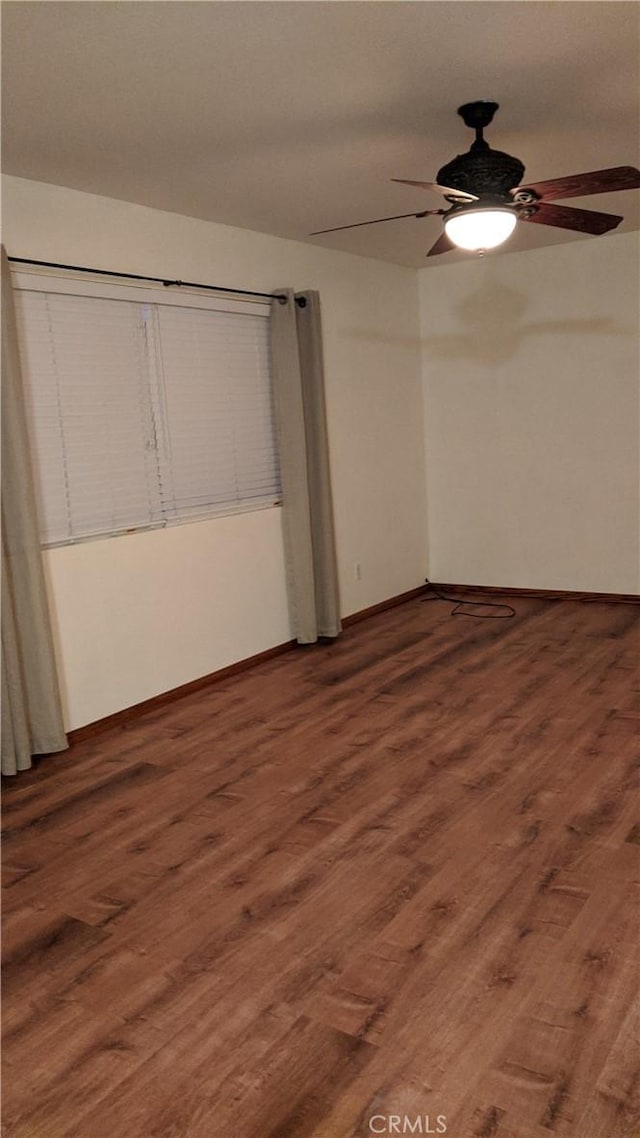 unfurnished bedroom featuring baseboards, ceiling fan, and wood finished floors