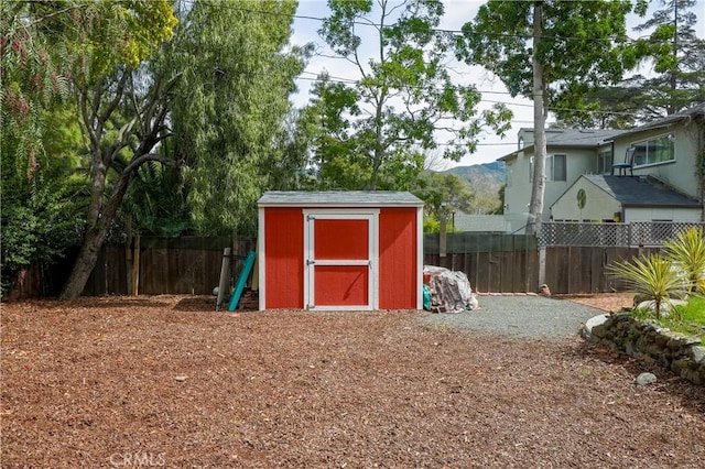 view of shed featuring fence private yard