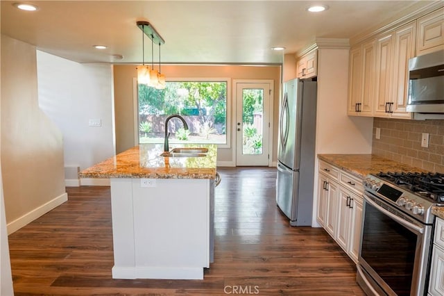 kitchen featuring a sink, tasteful backsplash, appliances with stainless steel finishes, and dark wood-style floors