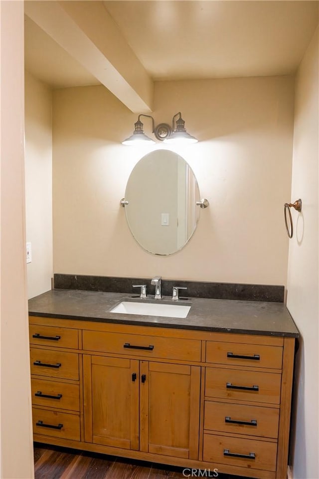 bathroom with wood finished floors and vanity